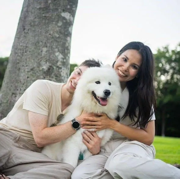 Chris, his wife, and the Samoyed under a tree